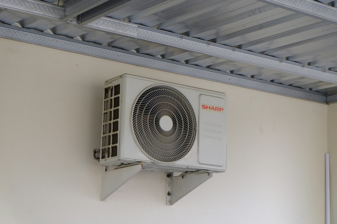Outdoor heat pump equipment mounted beside a building
